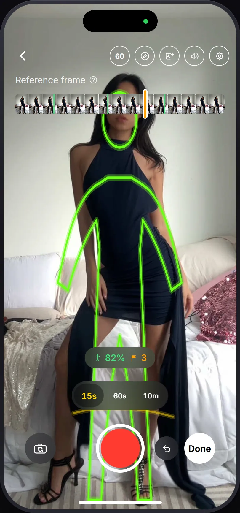 PoseCut's camera on a later take: the reference scrubber with green steady marks across the top, the traced outline of the previous take over the live camera, and a match percentage above the shutter.